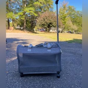 A pet travel carrier and roller. 2 doors on each side. Detachable roller base.